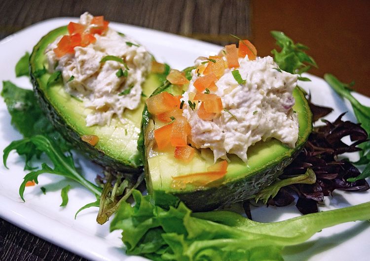 Avocados can be eaten in so many ways including by adding a salad to half an avocado