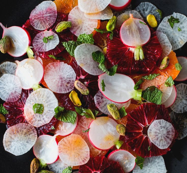 Radishes offer unique colors and texture to many dishes like in this orange and radish slices salad