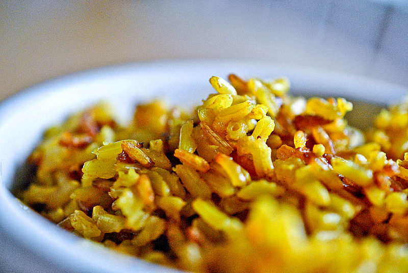 Bowl of Yellow Basmati Rice containing short grain brown rice, onion and turmeric